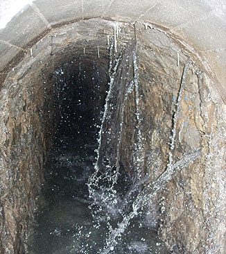 Sickerwasser in einem Stollen unterhalb eines Staudamms